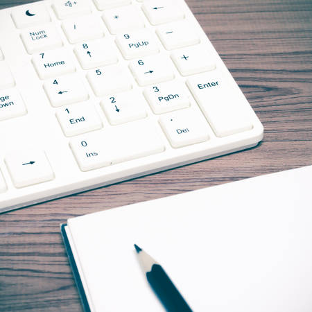 keyboard computer with notebook and pencil vintage styleの写真素材