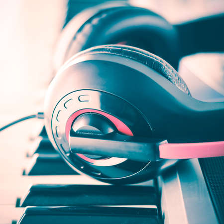 headphones on electric  music instrument piano keyboard vintage styleの写真素材
