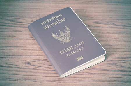 Thai passport on wood table background vintage styleの写真素材