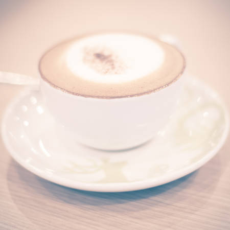 hot cappuccino on wood table vintage styleの写真素材