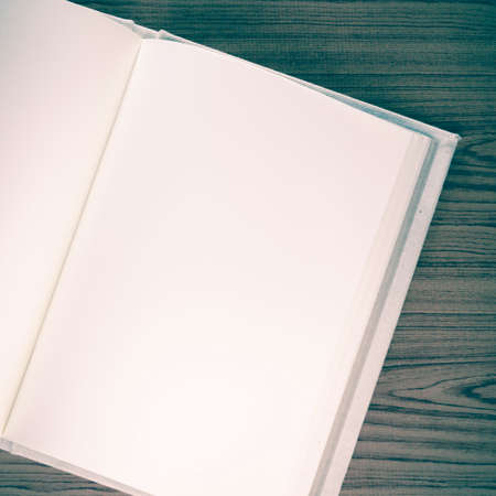 notebook on wood background vintage styleの写真素材