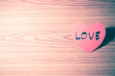red heart word LOVE on wood vintage stlye backgroundの写真素材