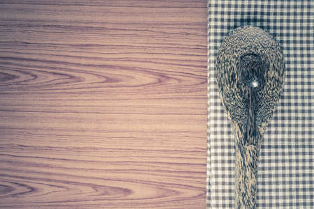 brown kitchen towel with spoon on wood background vintage styleの写真素材