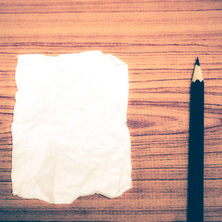 paper scrap with pencil on wood background vintage styleの写真素材