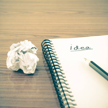 crumpled paper and pencil with notebook write idea word on wood background vintage style