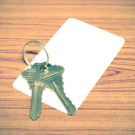 business card and keys on wood background vintage style