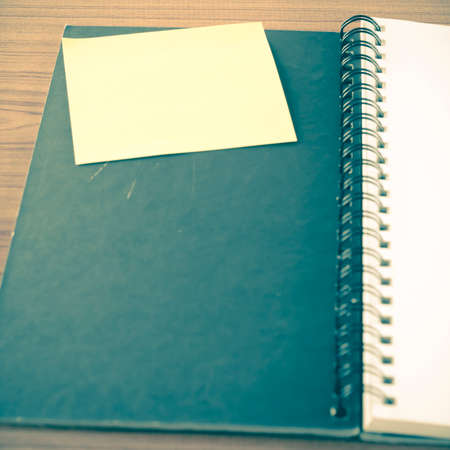 open notebook with post it on wood background vintage styleの写真素材