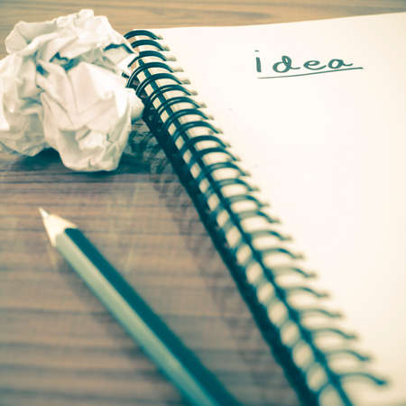 crumpled paper and pencil with notebook write idea word on wood background vintage styleの写真素材