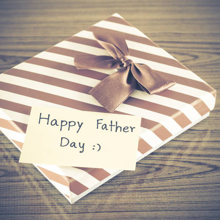 gift box with card write happy father day on wood background vintage styleの写真素材