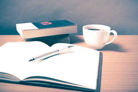 open book with coffee on wood background vintage styleの写真素材