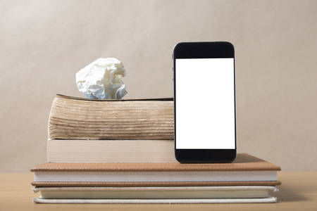 stack of book and smart phone on wood backgroundの写真素材