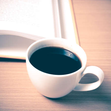 open book with coffee on wood background vintage styleの写真素材