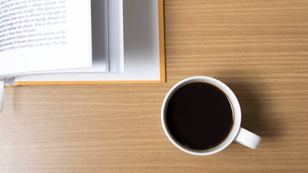 open book with coffee on wood backgroundの写真素材