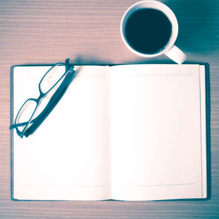 open book with coffee cup on wood background vintage styleの写真素材