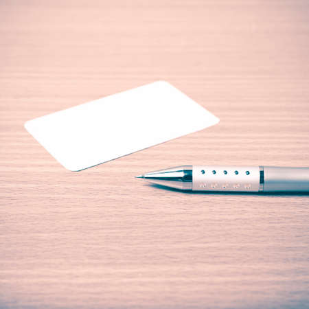 business card and pen on wood background vintage styleの写真素材