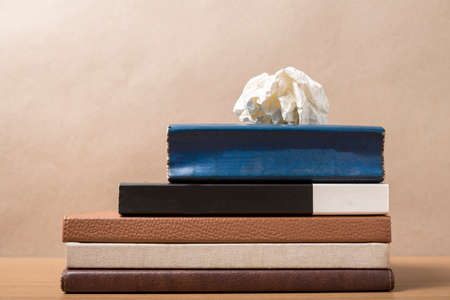 book and crumpled paper on wood backgroundの写真素材