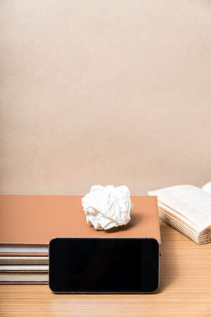 stack of book with smart phone on wood backgroundの写真素材