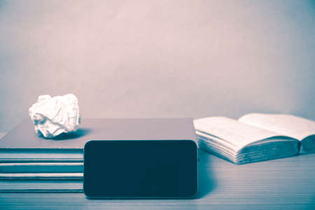 stack of book with smart phone on wood background vintage styleの写真素材