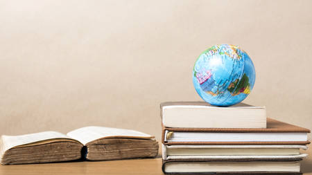 book and earth ball on wood backgroundの写真素材
