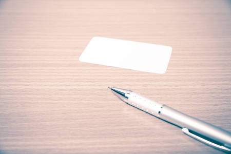 business card and pen on wood background vintage styleの写真素材