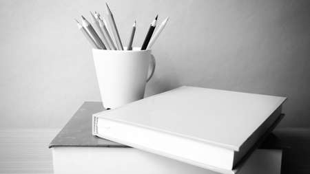 stack of book with pencil on wood table background black and white color tone styleの写真素材