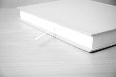 book on wood table background black and white color tone styleの写真素材
