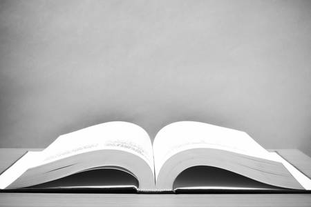 open book on wood background black and white color tone style