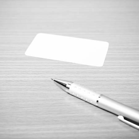 business card and pen on wood background black and white color tone styleの写真素材