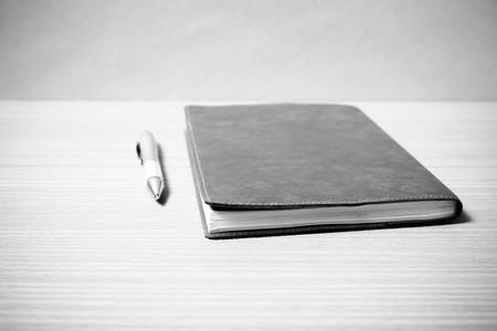 book and pen on wood background black and white color tone style