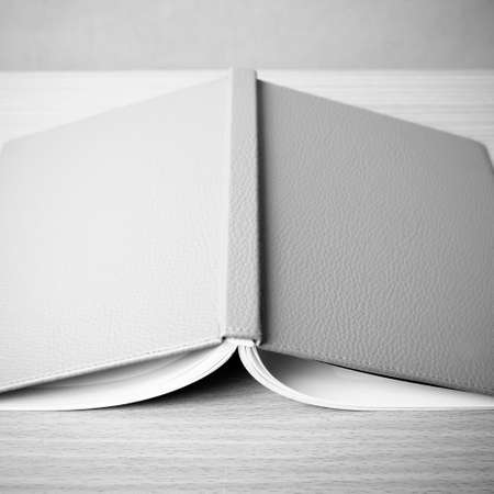 book on wood table background black and white color tone style