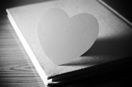 diary of love with notebook and heart on wood background black and white color tone styleの写真素材