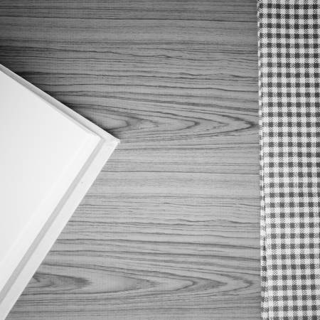 notebook with kitchen towel on wood background black and white color tone style