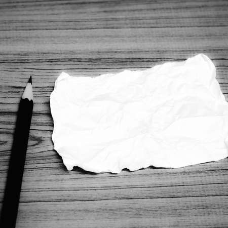 paper scrap with pencil on wood black and white color tone styleの写真素材