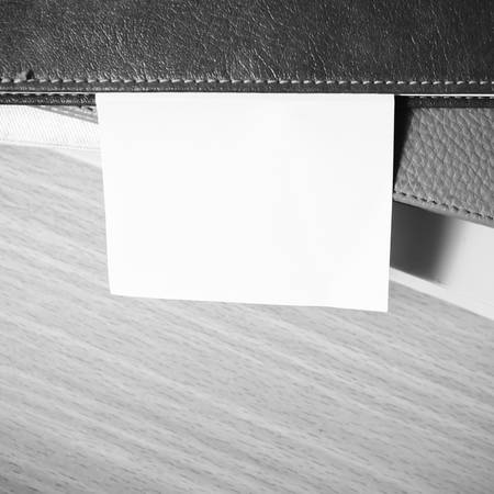 stack of book with sticky note on wood black and white color tone styleの写真素材