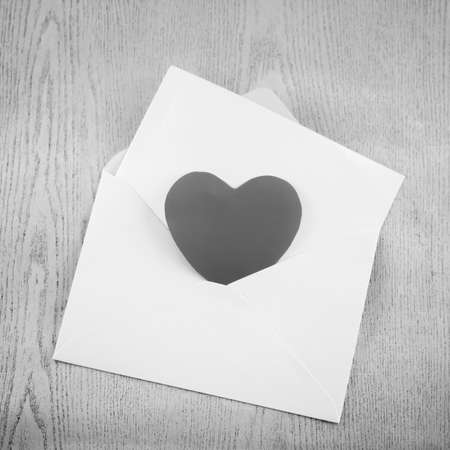 heart with envelope on wooden black and white color tone styleの写真素材