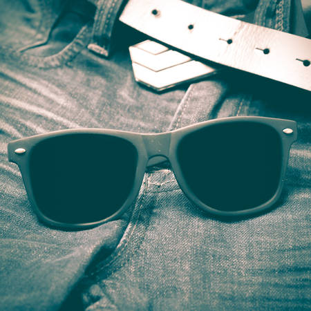 sunglasses on jean pants retro vintage styleの写真素材