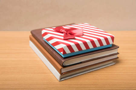 book with gift box on wood backgroundの写真素材