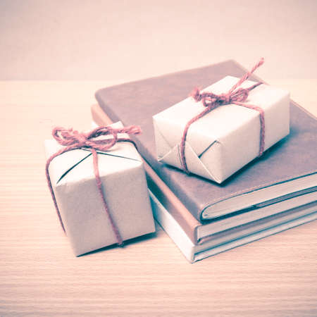 book with gift box on wood background vintage styleの写真素材