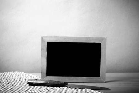 blackboard and knife on table black and white color tone styleの写真素材