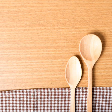 wood spoon and kitchen towel on tableの写真素材