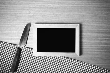 blackboard and knife on table black and white color tone styleの写真素材