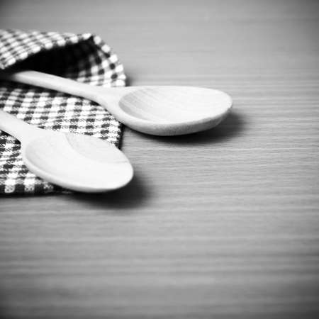 wood spoon and kitchen towel on table black and white color tone styleの写真素材