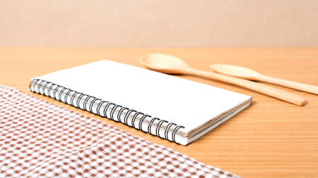 notebook and kitchen tools on tableの写真素材