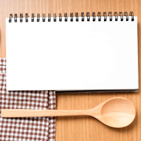notebook and kitchen tools on tableの写真素材
