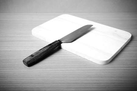 knife and cutting board on table black and white color tone styleの写真素材