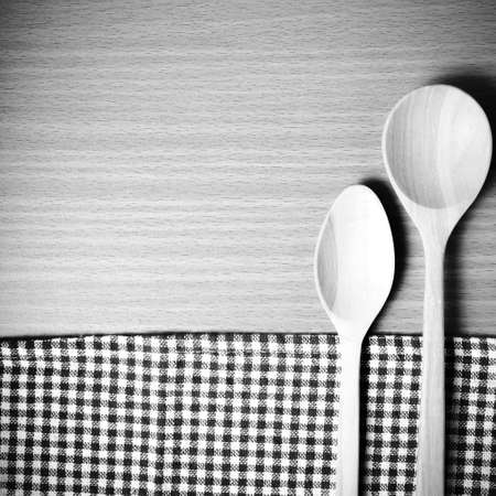 wood spoon and kitchen towel on table black and white color tone styleの写真素材