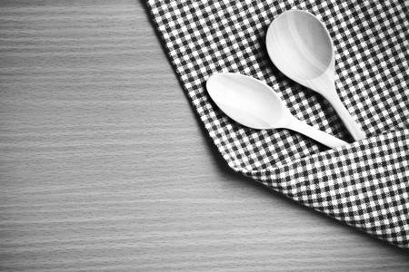 wood spoon and kitchen towel on table black and white color tone style