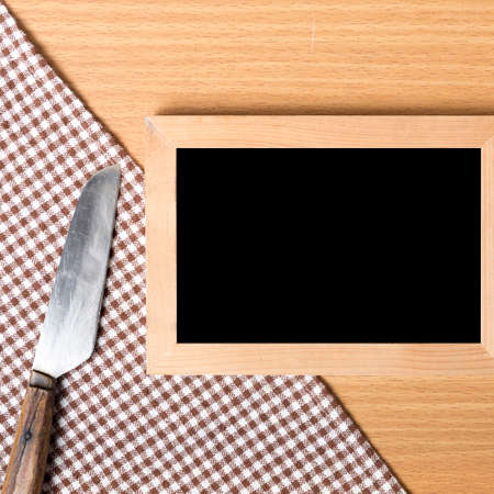 blackboard and knife on tableの写真素材