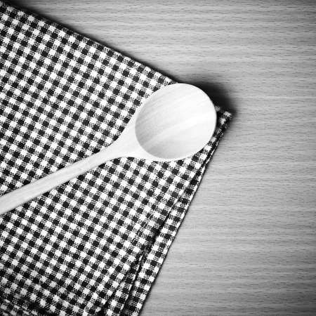 wood spoon and kitchen towel on table black and white color tone styleの写真素材