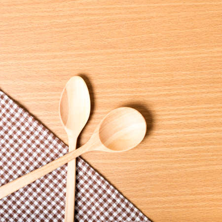 wood spoon and kitchen towel on tableの写真素材